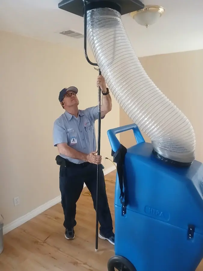 Furnace Tune-Up technician using HEPA equipment in Spring Lake Park